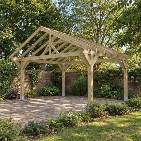 A natural wood gazebo with a gable roof and open side panels, shown installed on a paved patio in a UK landscaped garden with trees, brick wall, and shrubs.
