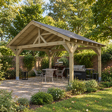 A large wooden garden gazebo with a dark felt shingle roof is shown in a UK landscaped back patio garden setting, featuring a dining table and chairs, a grill, and outdoor greenery.
