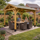 People sitting at a dining table under a wooden gazebo in a garden setting.