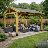 People sitting under a wooden gazebo in a garden setting